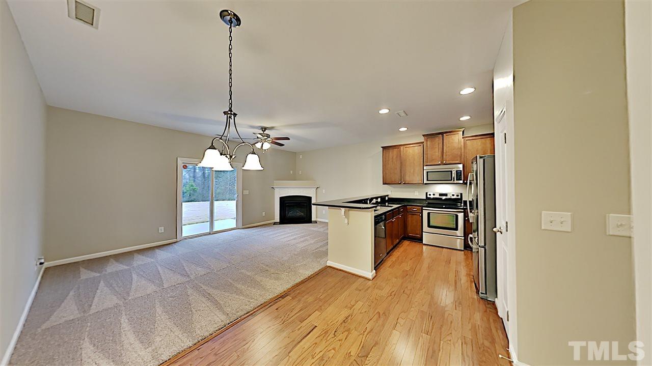 2238 Stoney Spring Drive Raleigh, NC 27610 - Photo 5 of 11 a view of kitchen with dining table chairs and refrigerator