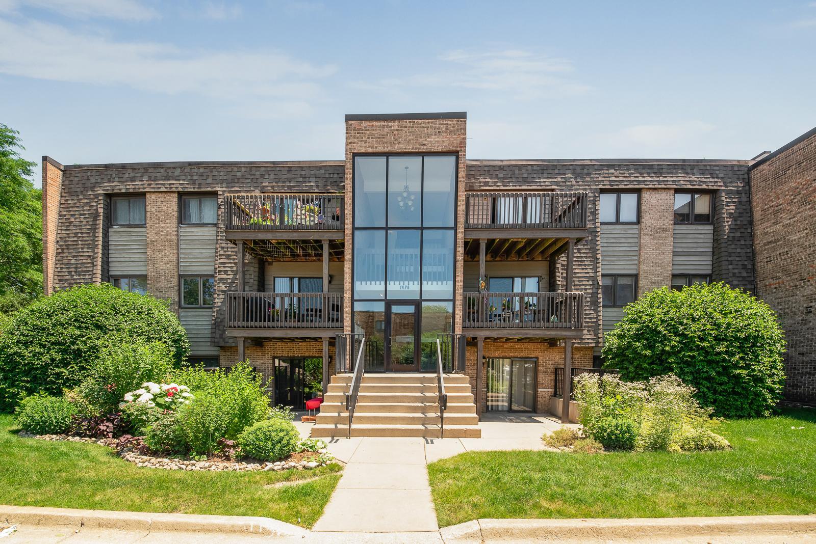 1420 Stonebridge Circle, Unit 5N Wheaton, IL 60189 - Photo 1 of 14 front view of a brick house