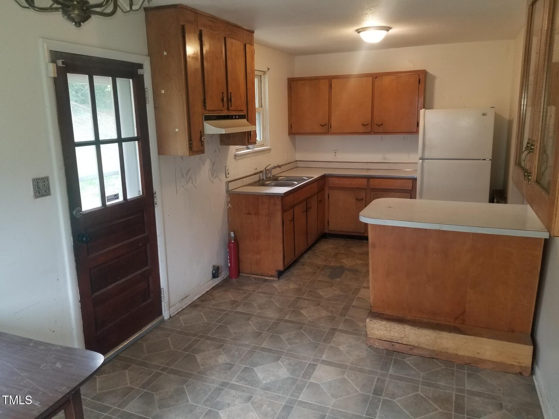 2017 Waters Drive Raleigh, NC 27610 - Photo 3 of 11 a kitchen with a refrigerator and a stove
