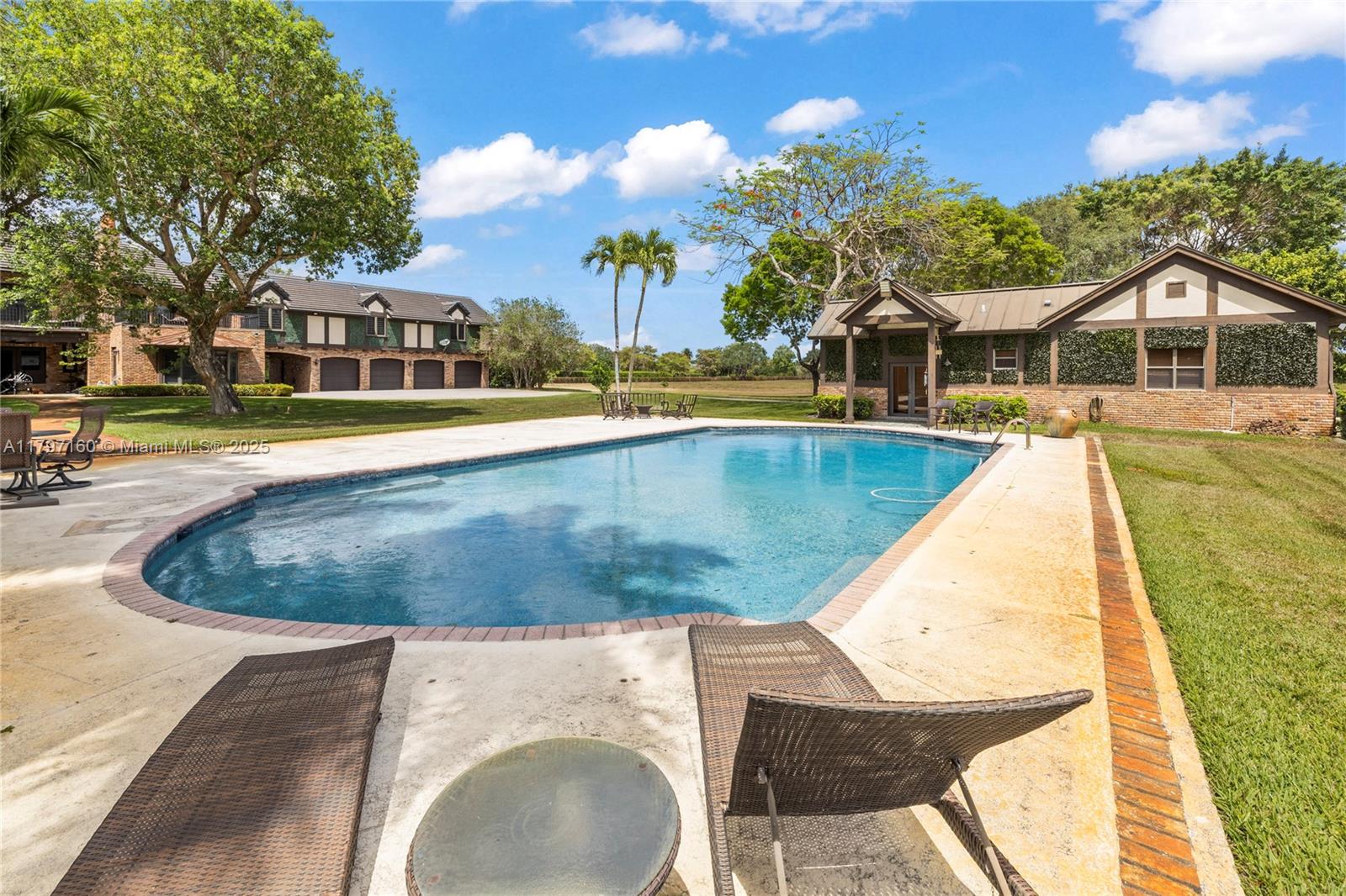 8700 Surrey Lane Boca Raton, FL 33496 - Photo 4 of 10 a view of a swimming pool with a patio