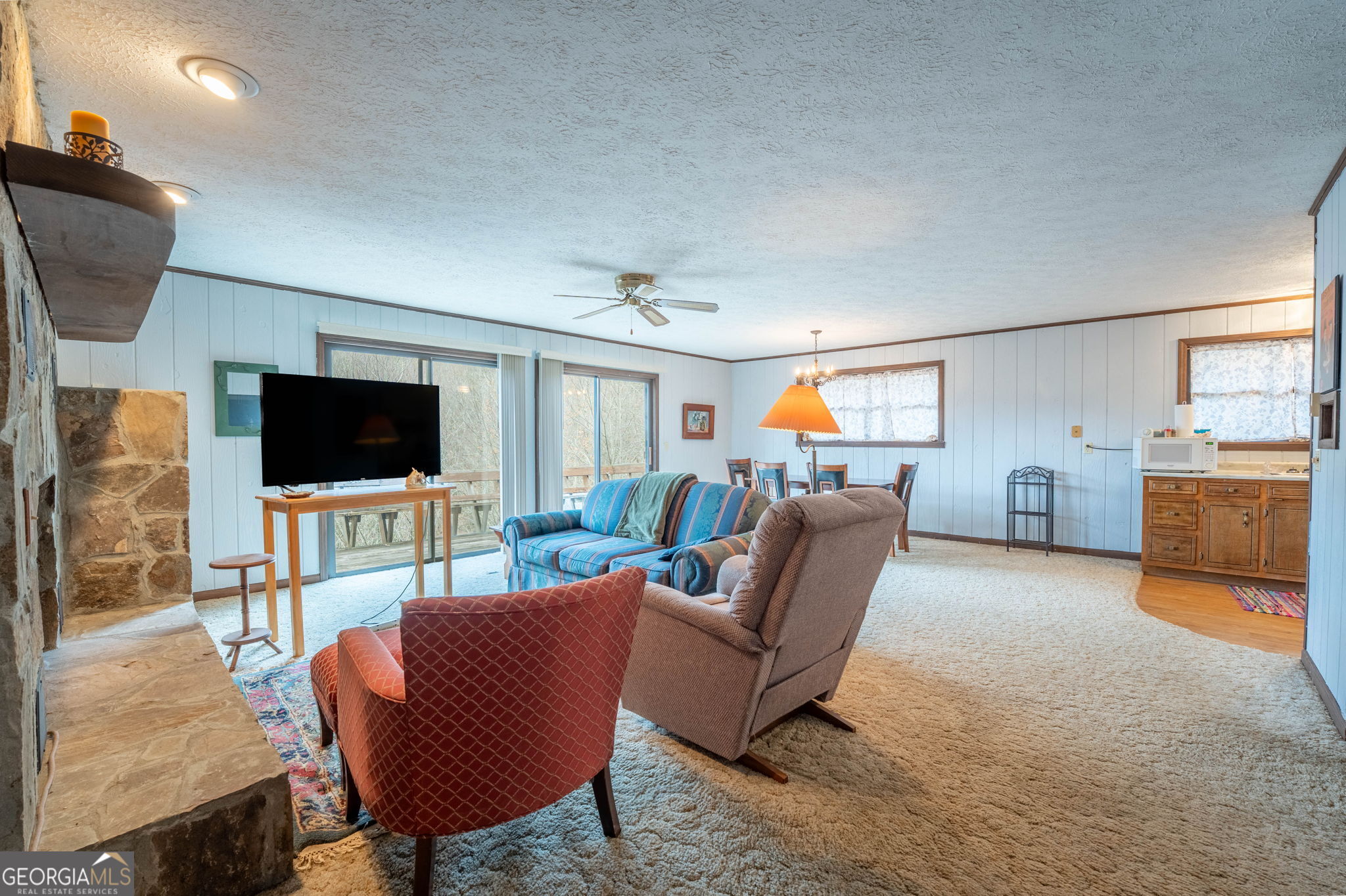375 Western Way Rabun Gap, GA 30568 - Photo 11 of 51 a living room with furniture and a flat screen tv
