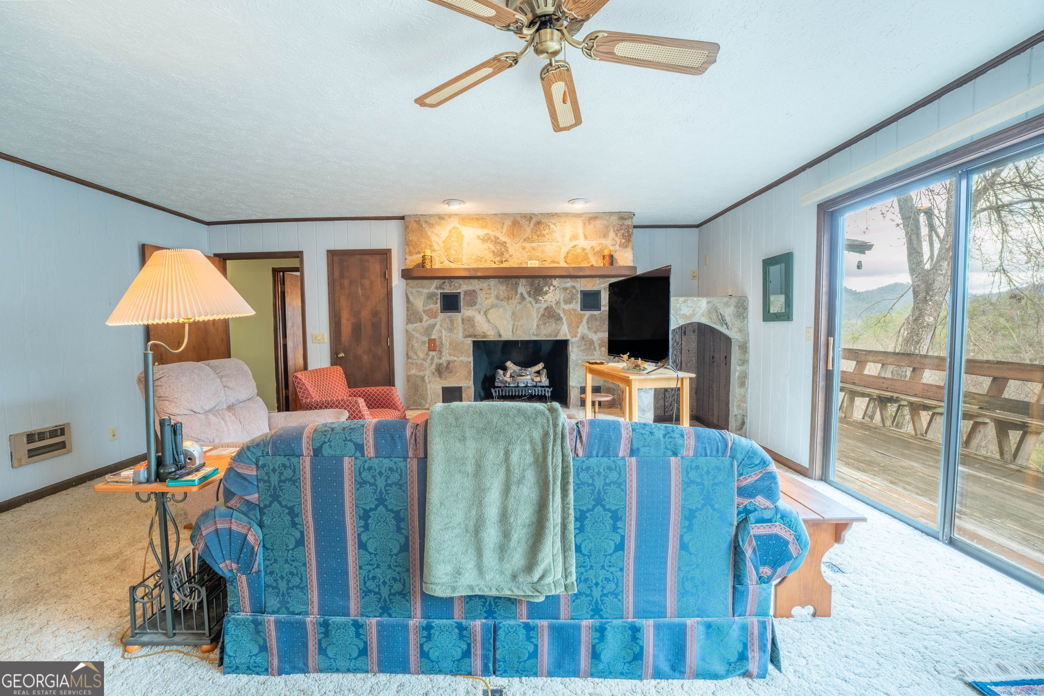 375 Western Way Rabun Gap, GA 30568 - Photo 13 of 51 a living room with fireplace furniture and a large window