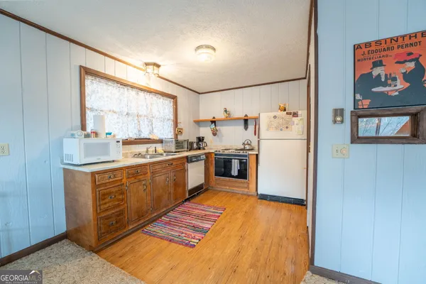 a kitchen with stainless steel appliances granite countertop a refrigerator sink and cabinets