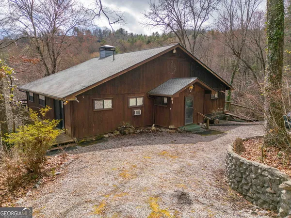 a view of a house with a yard covered in snow