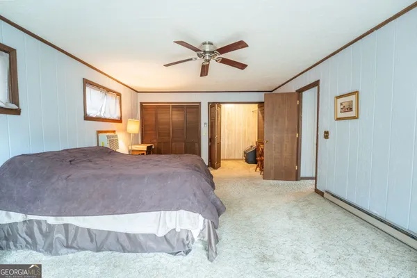 a bedroom with furniture and a closet