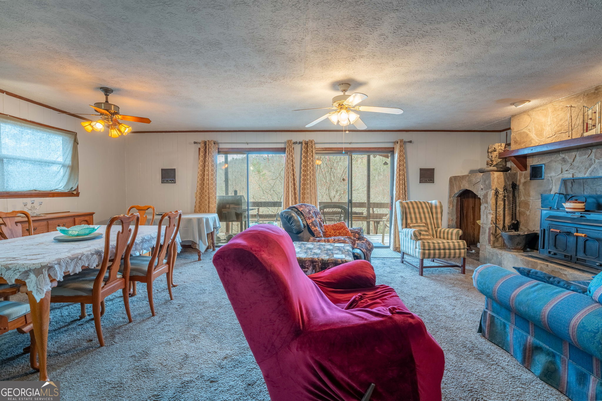 375 Western Way Rabun Gap, GA 30568 - Photo 28 of 51 a living room with furniture a fireplace and a flat screen tv