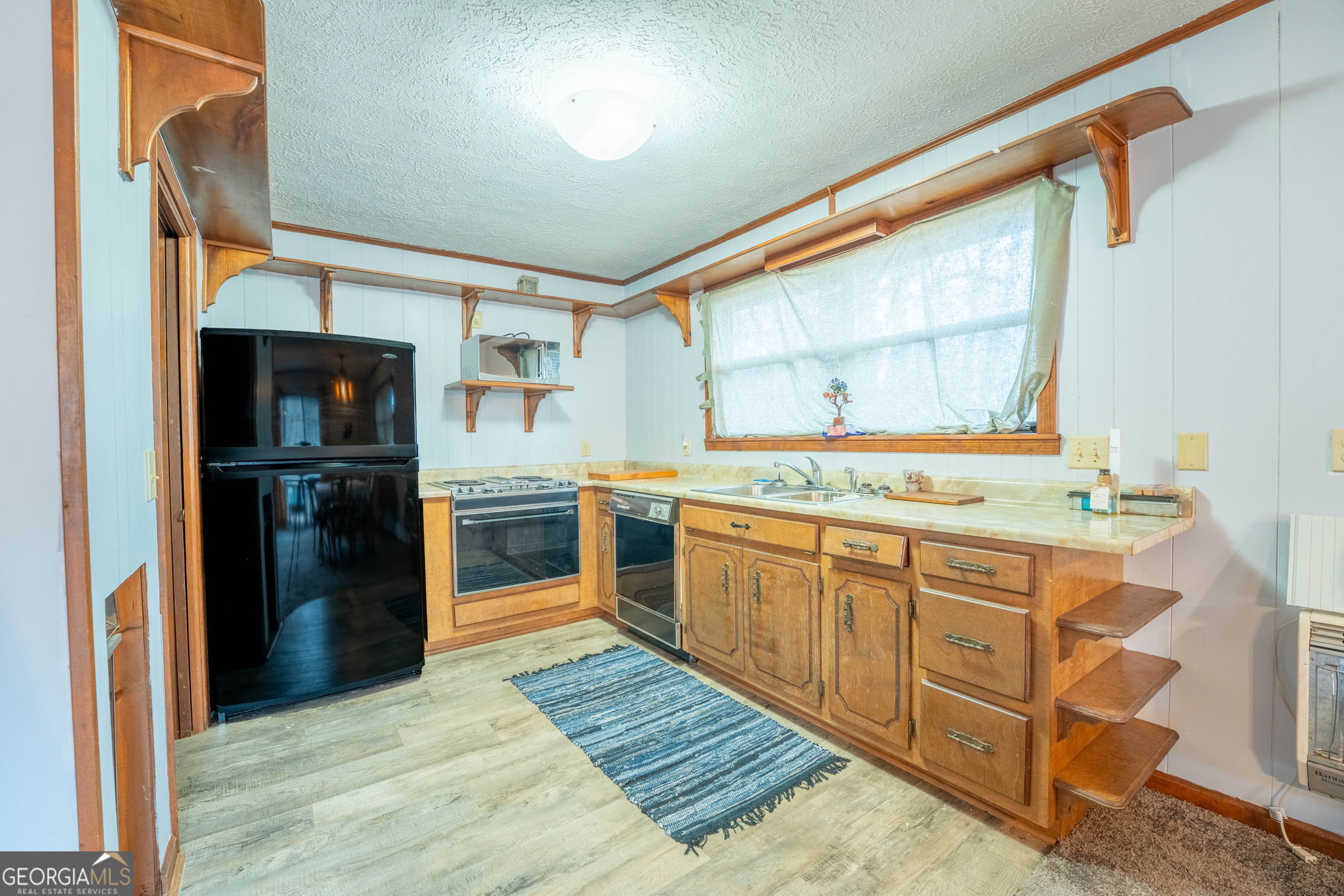 375 Western Way Rabun Gap, GA 30568 - Photo 30 of 51 a kitchen with stainless steel appliances granite countertop a refrigerator and a sink