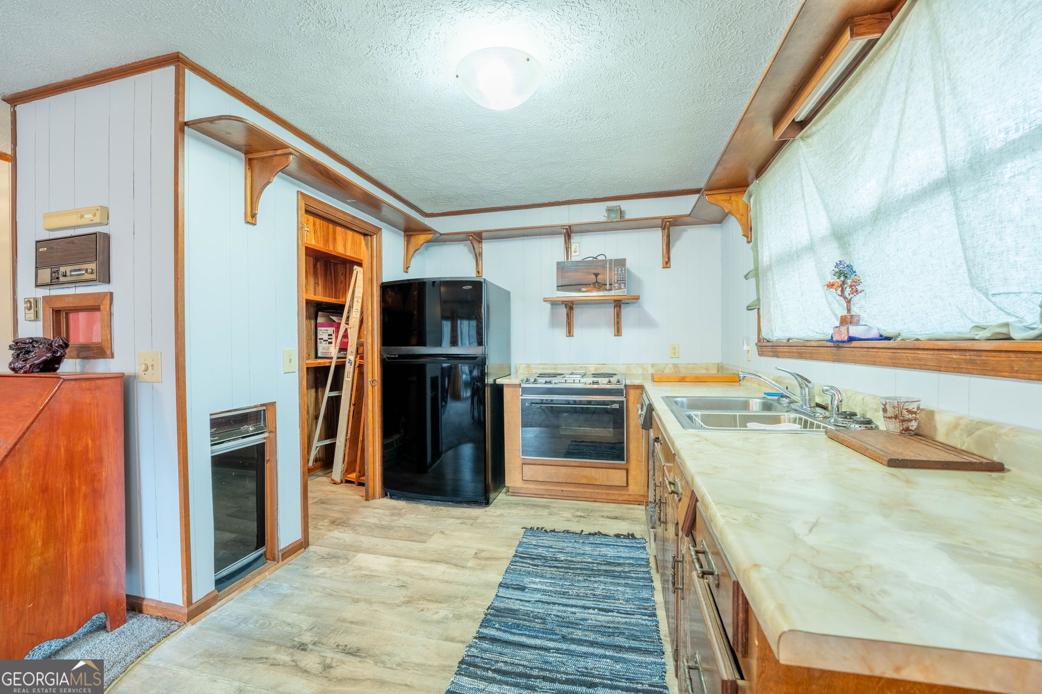 375 Western Way Rabun Gap, GA 30568 - Photo 31 of 51 a kitchen with stainless steel appliances granite countertop a refrigerator and a sink