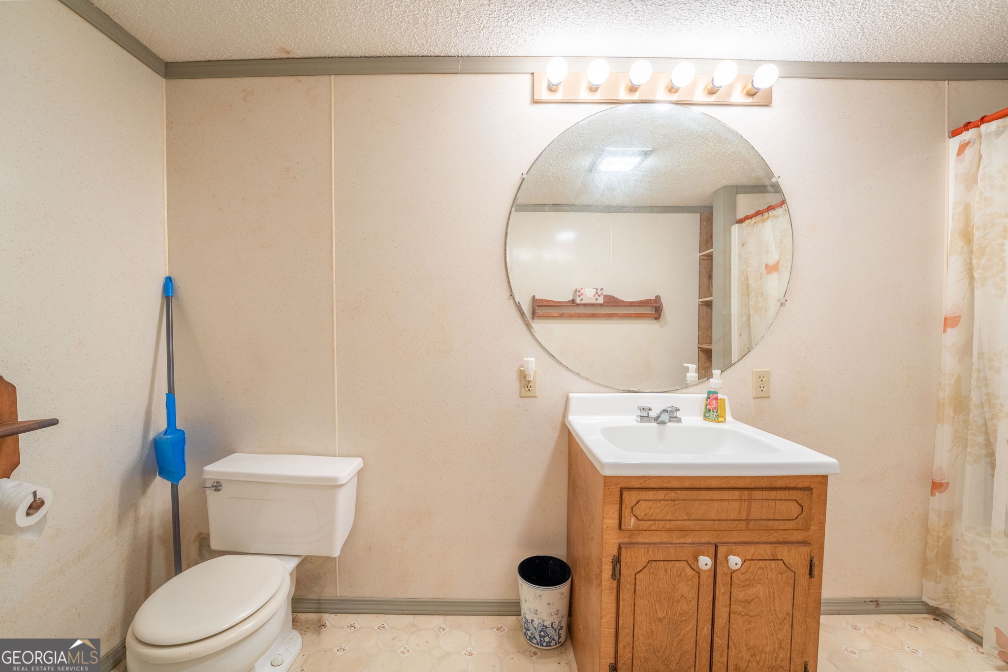 375 Western Way Rabun Gap, GA 30568 - Photo 33 of 51 a bathroom with a sink mirror vanity and toilet