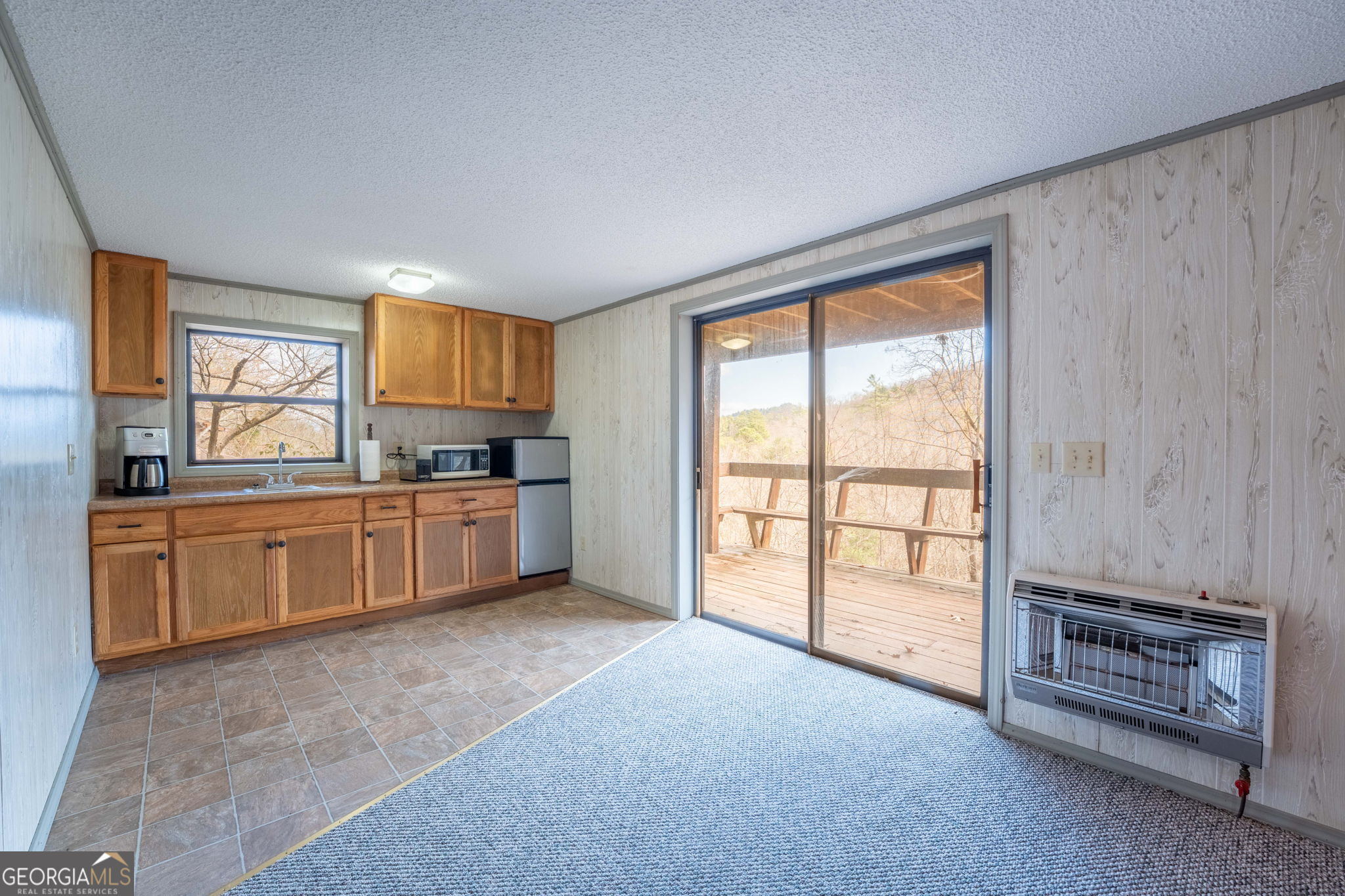 375 Western Way Rabun Gap, GA 30568 - Photo 38 of 51 a kitchen with stainless steel appliances a stove top oven a sink and a refrigerator with white cabinets