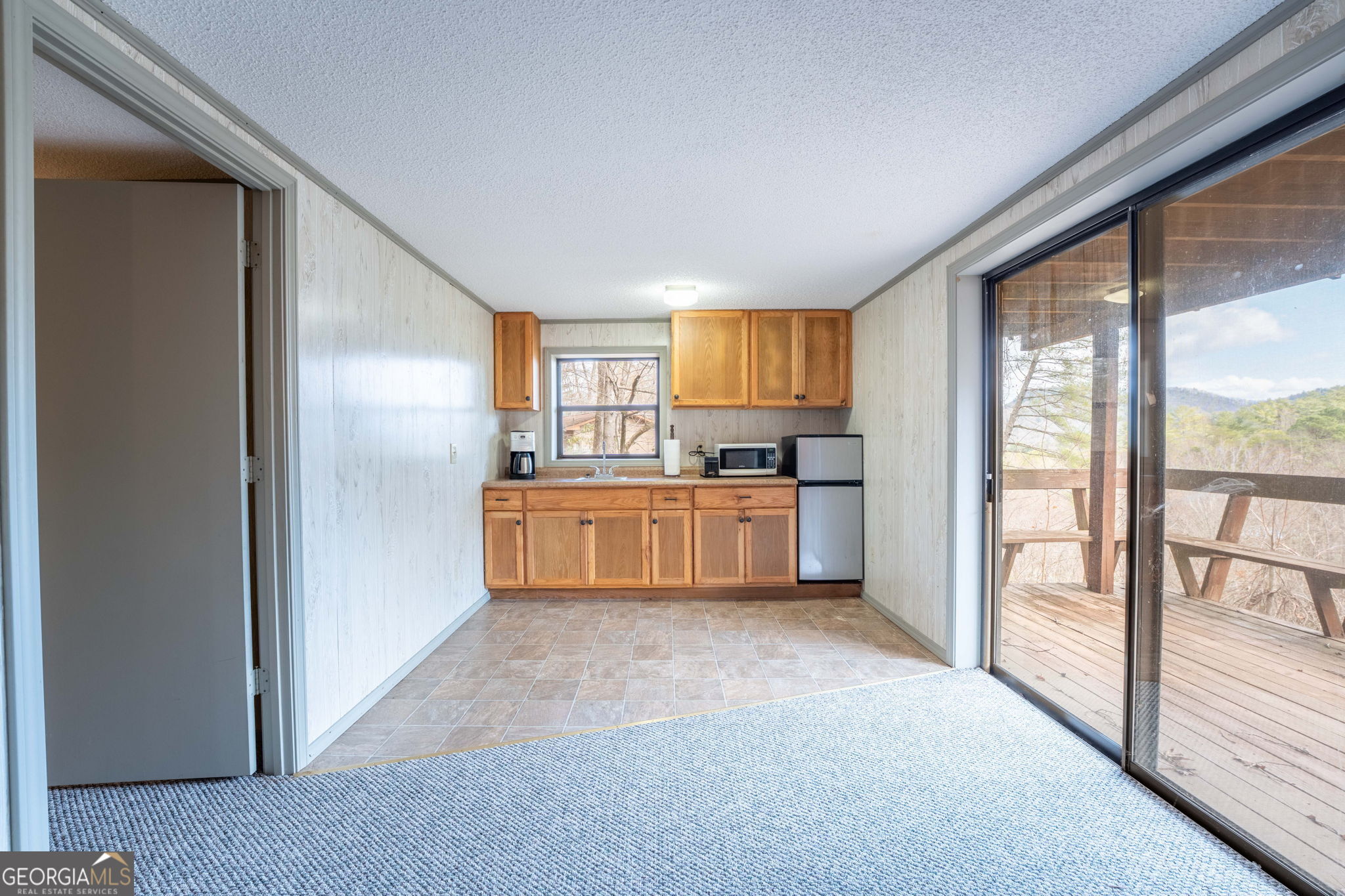 375 Western Way Rabun Gap, GA 30568 - Photo 39 of 51 a kitchen with white cabinets and white appliances