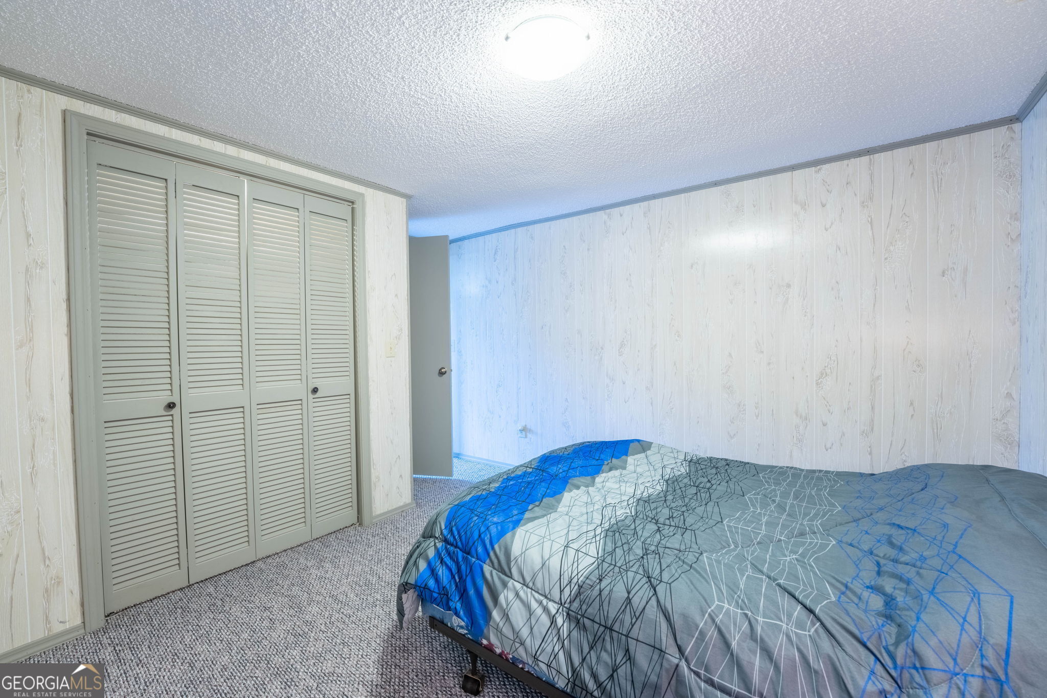 375 Western Way Rabun Gap, GA 30568 - Photo 41 of 51 a bedroom with a bed and a closet