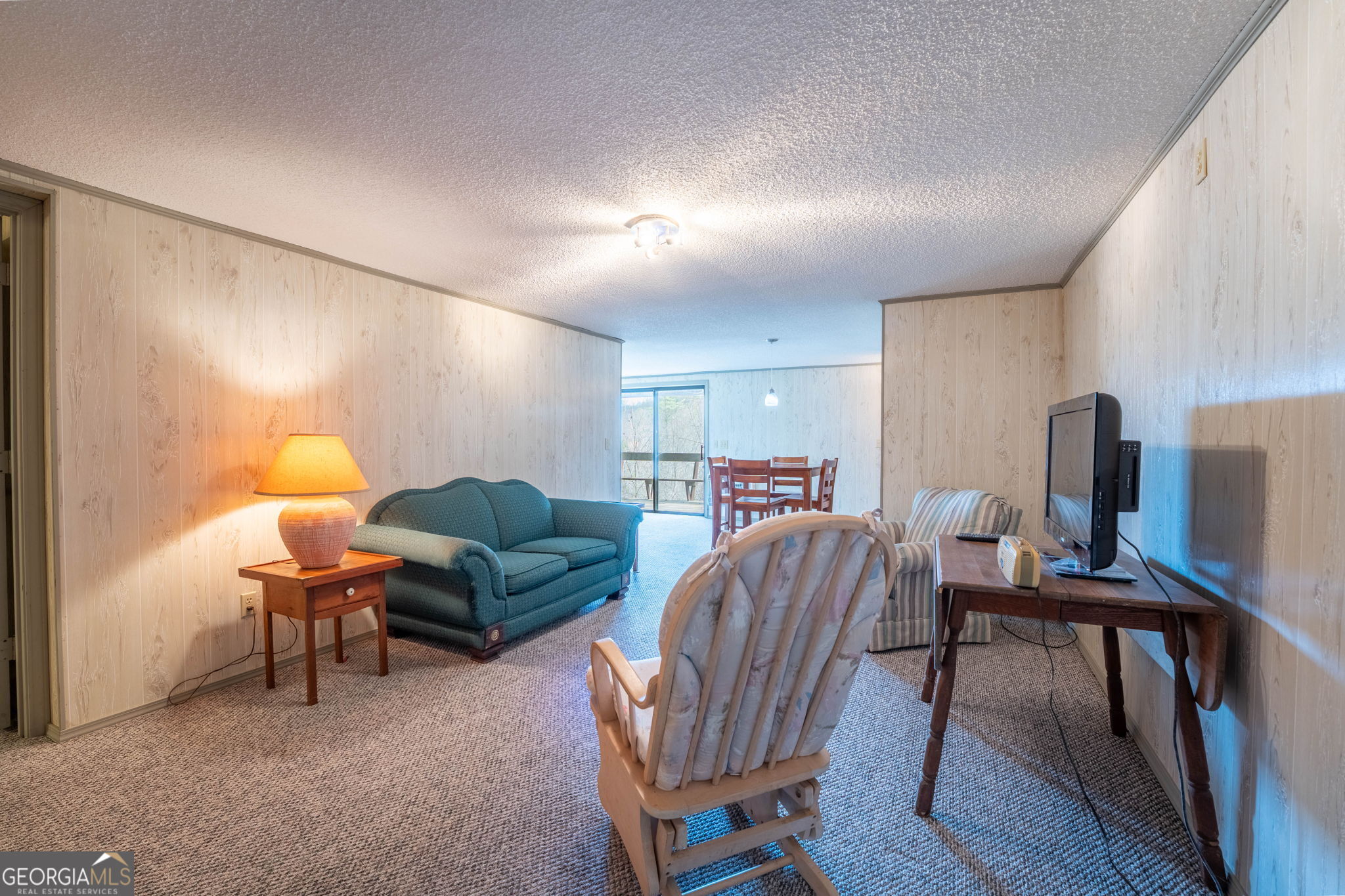 375 Western Way Rabun Gap, GA 30568 - Photo 43 of 51 a living room with furniture a dining table and a refrigerator