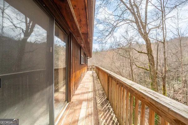 a view of a balcony with wooden floor and fence