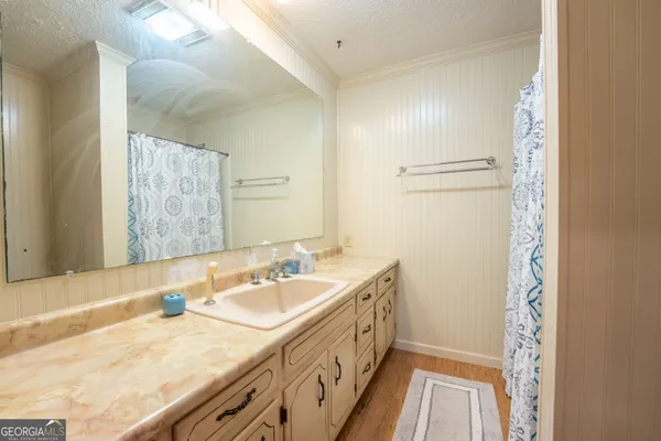 a bathroom with a granite countertop sink and a bathtub