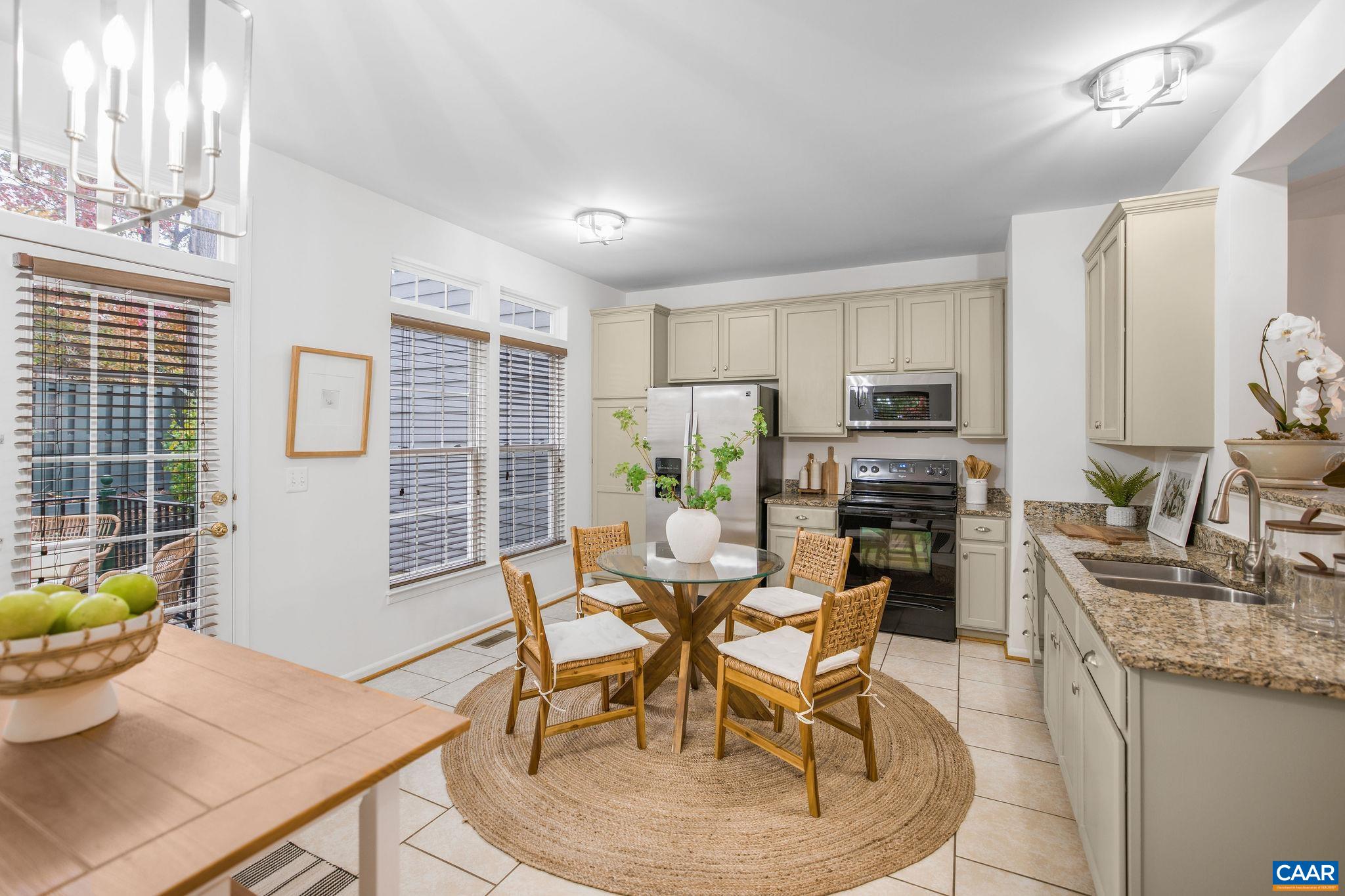 843 Rainier Road Charlottesville, VA 22903 - Photo 18 of 41 a dining room with stainless steel appliances a dining table and chairs