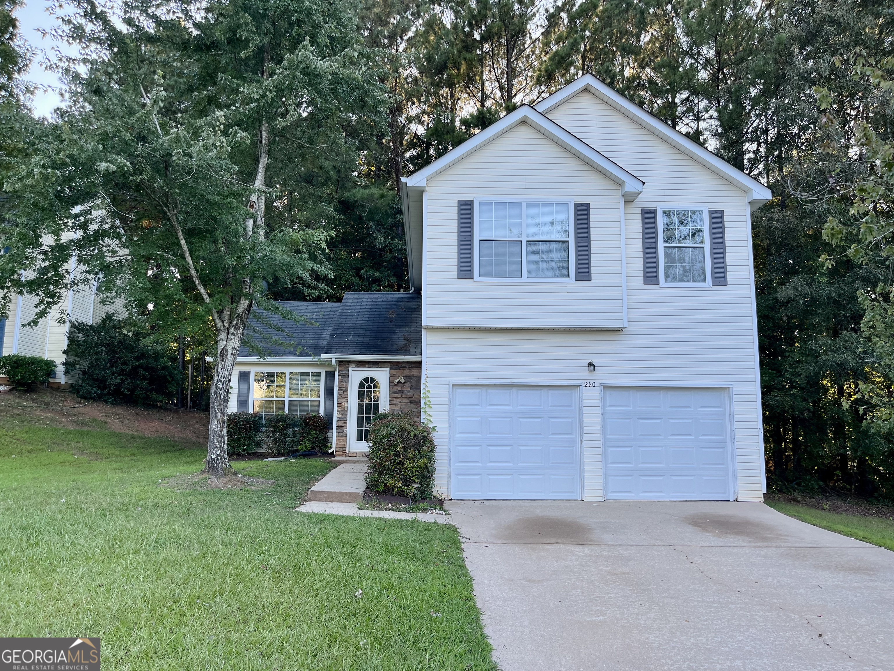 260 Windscape Drive Covington, GA 30016 - Photo 1 of 14 a front view of a house with a yard and garage