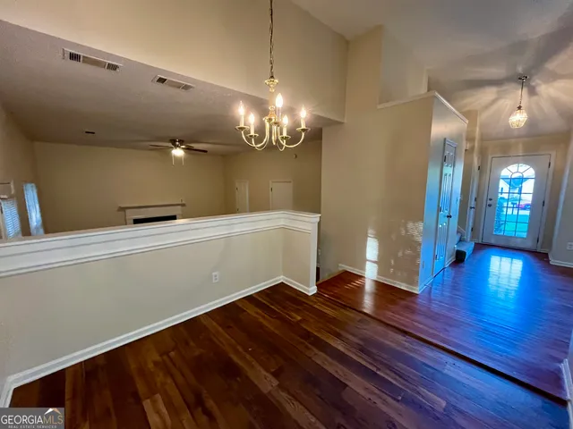 a view of a room with wooden floor