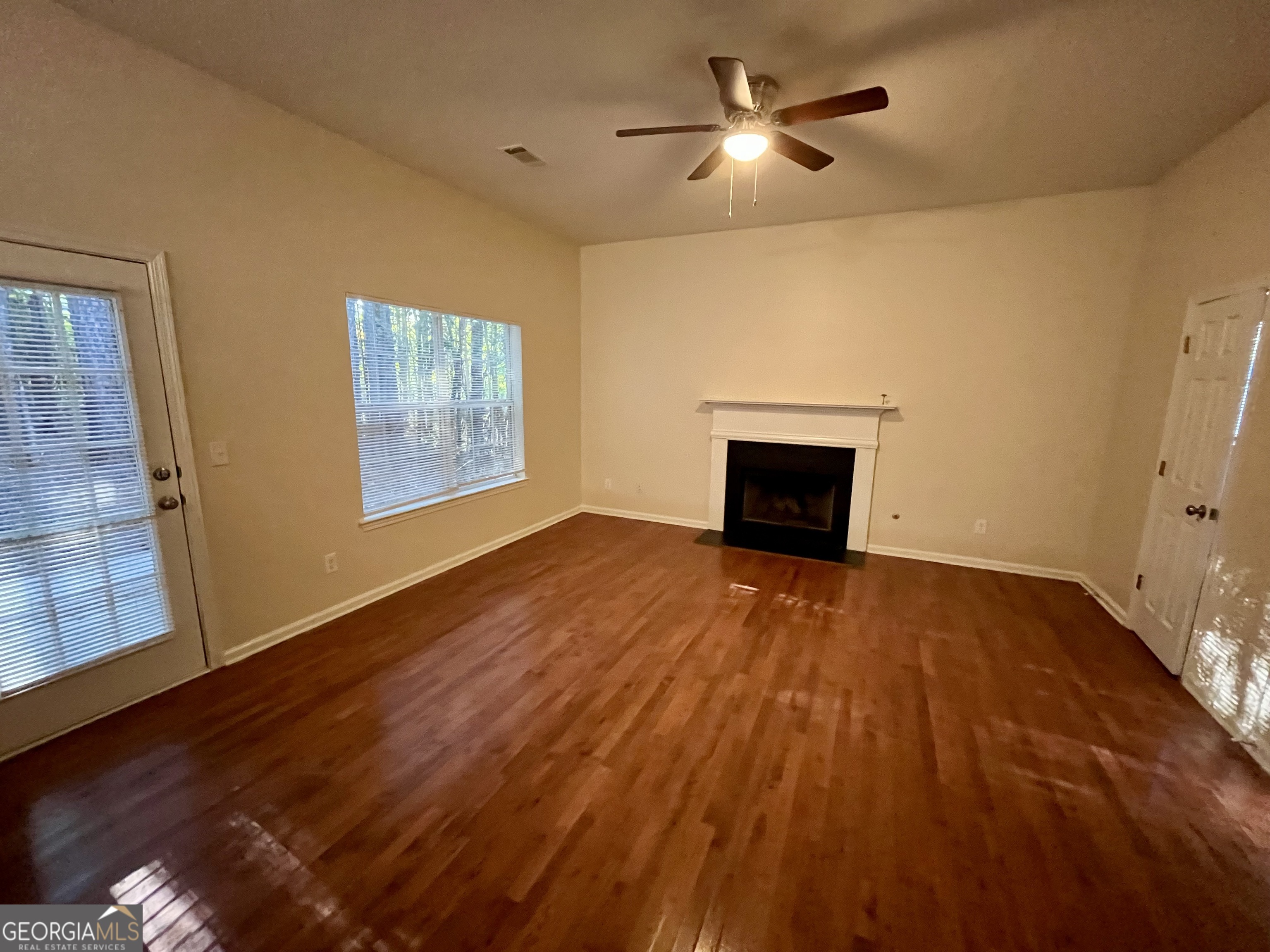 260 Windscape Drive Covington, GA 30016 - Photo 6 of 14 a view of empty room with wooden floor and fan