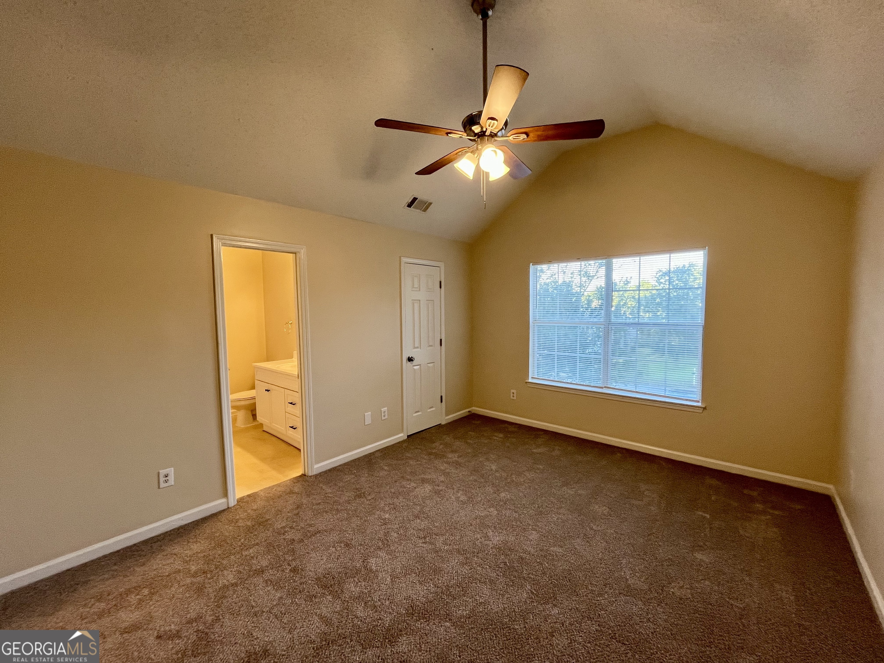 260 Windscape Drive Covington, GA 30016 - Photo 8 of 14 an empty room with a ceiling fan and a window