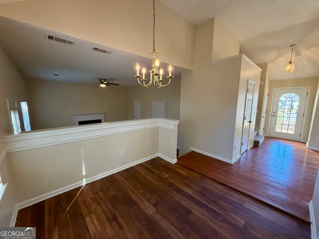 a view of a room with wooden floor