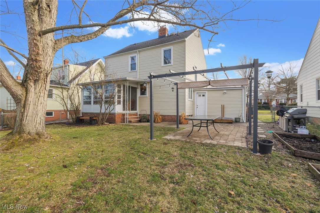 1444 Gordon Road Lyndhurst, OH 44124 - Photo 31 of 33 Back of house with a pergola, a lawn, a sunroom, and a patio area