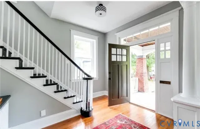 a view of entryway and hall with wooden floor
