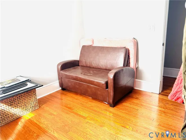 a blue couch sitting on top of a wooden floor