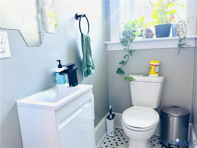 a bathroom with a sink mirror vanity and toilet