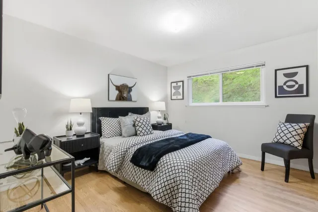 a bedroom with a bed and a window