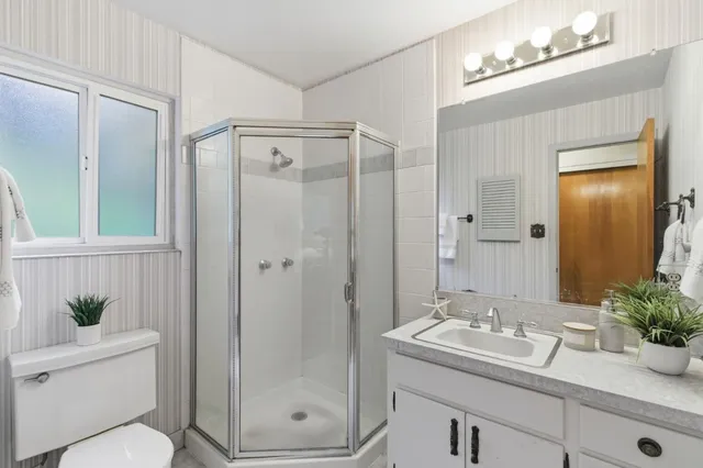 a bathroom with a sink toilet and shower