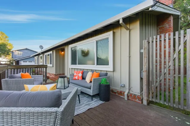 a balcony with furniture and wooden floor