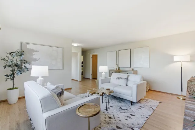 a living room with furniture or couch and a potted plant