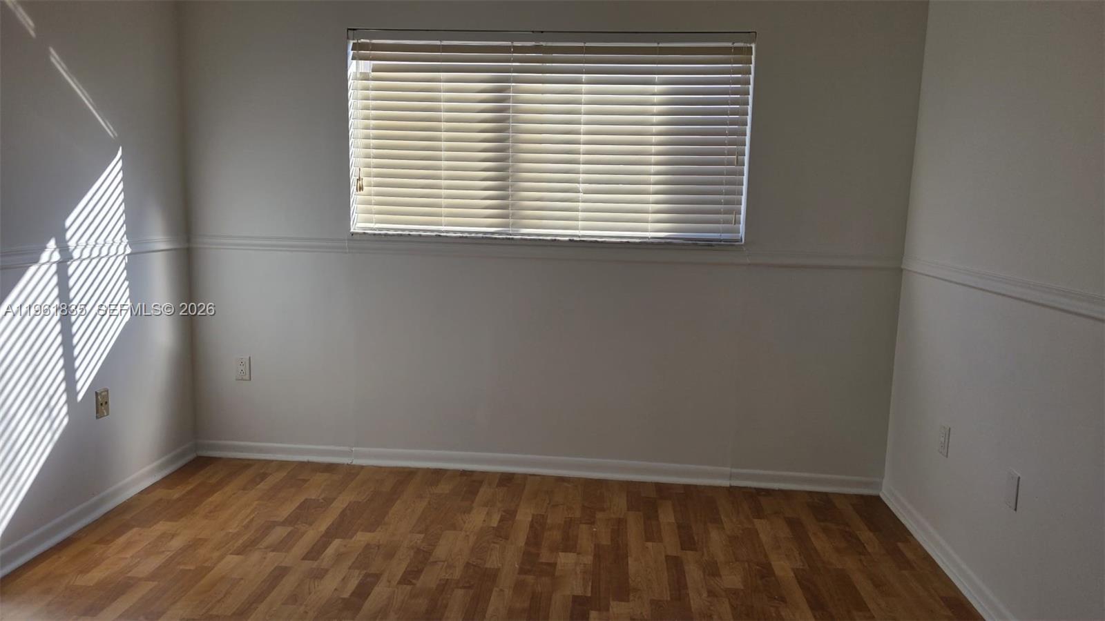 14905 Southwest 80th Street, Unit 217 Miami, FL 33193 - Photo 13 of 25 an empty room with a window