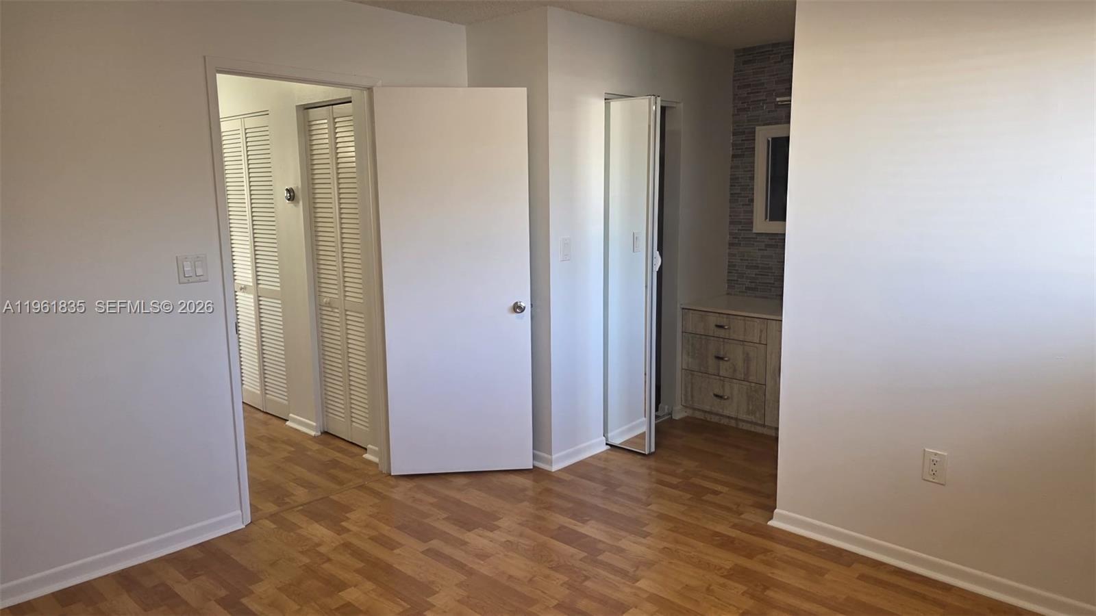14905 Southwest 80th Street, Unit 217 Miami, FL 33193 - Photo 20 of 25 an empty room with closet and wooden floor