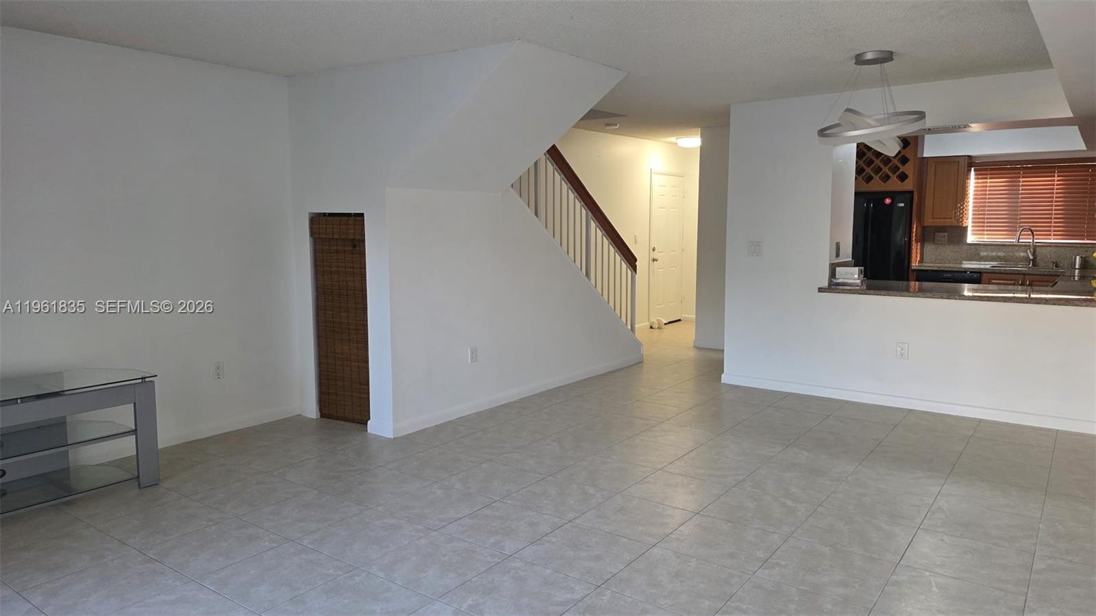 14905 Southwest 80th Street, Unit 217 Miami, FL 33193 - Photo 23 of 25 a view of a hallway with wooden floor and staircase
