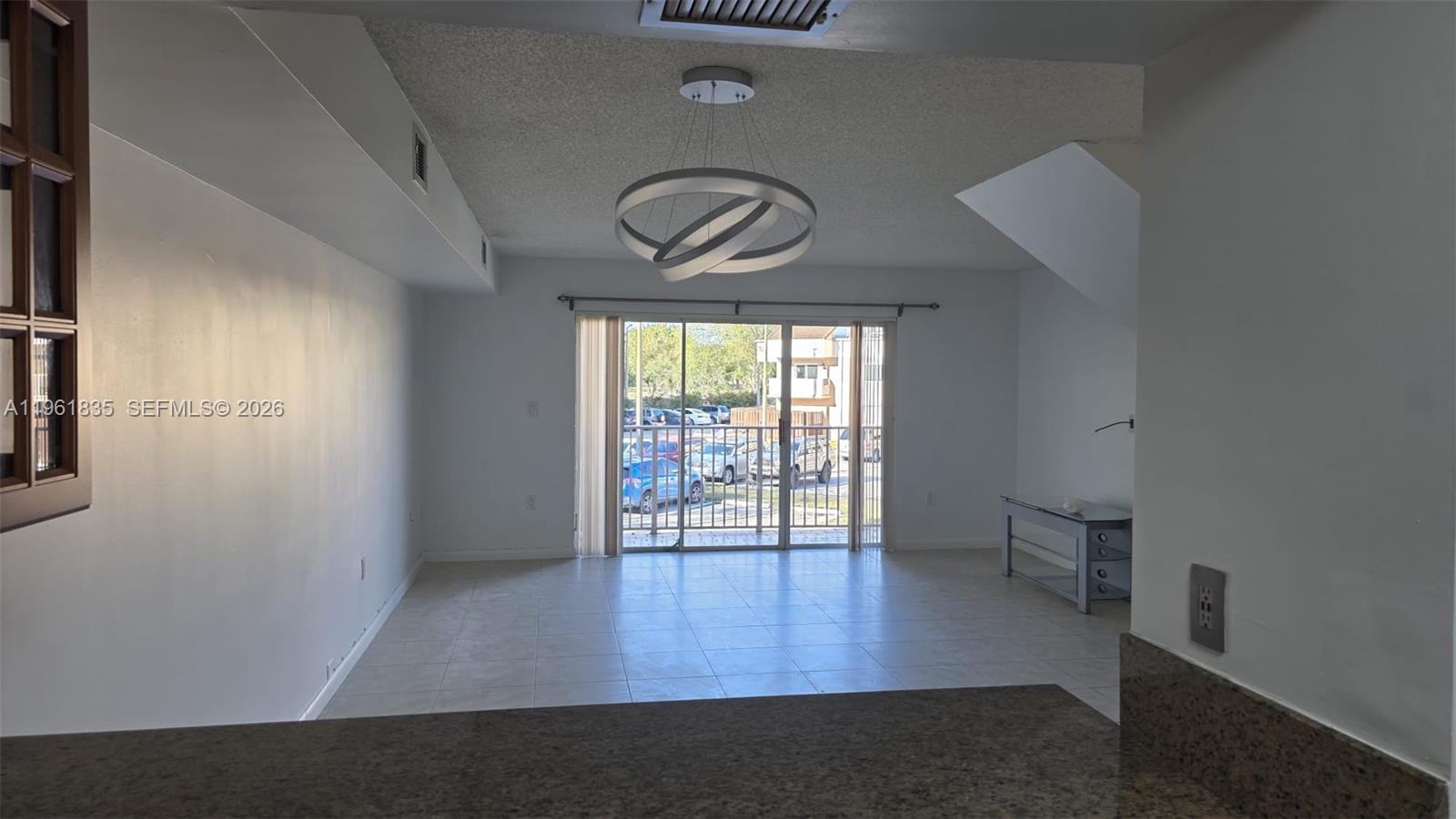14905 Southwest 80th Street, Unit 217 Miami, FL 33193 - Photo 6 of 25 an empty room with wooden floor and windows