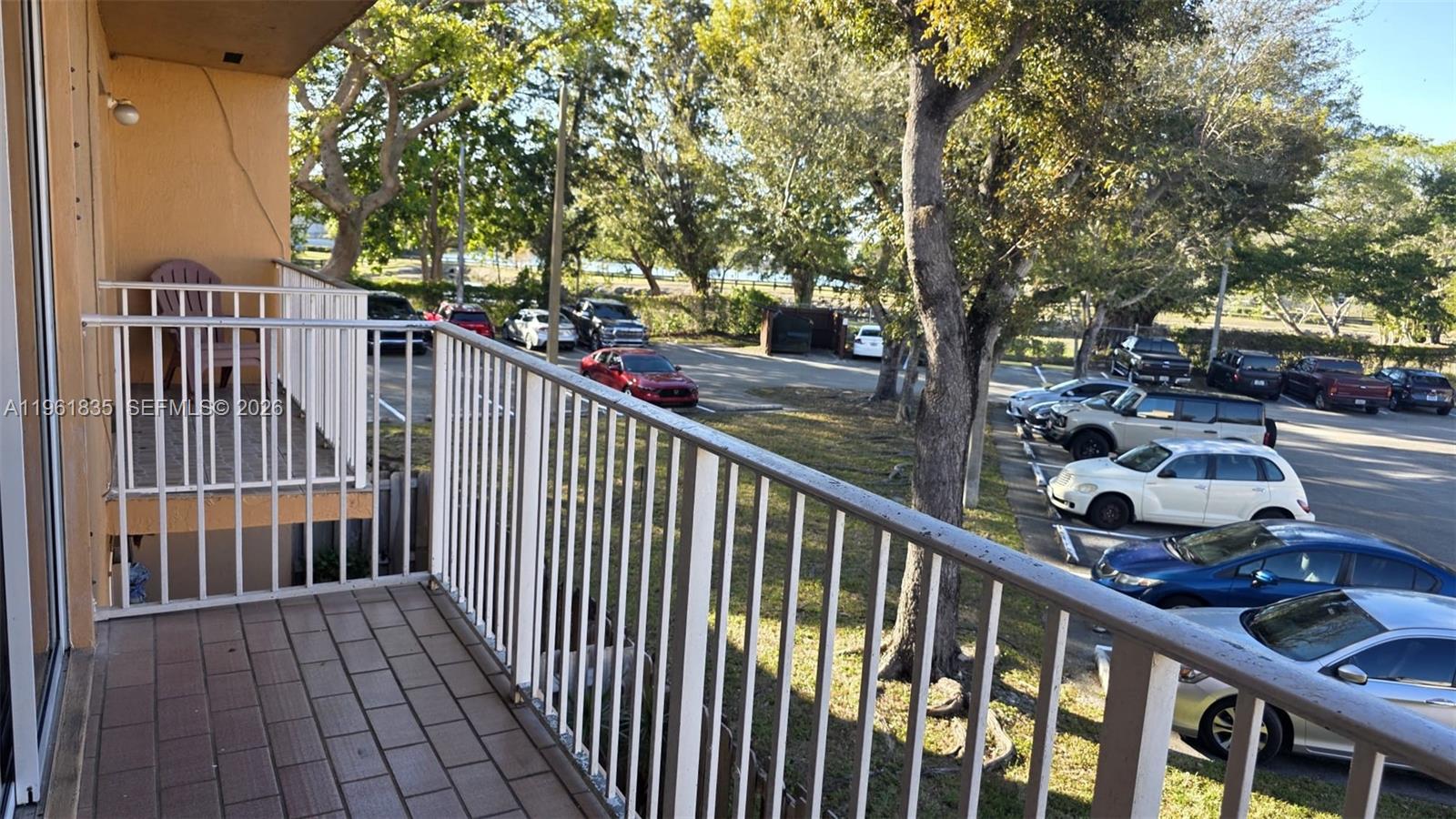14905 Southwest 80th Street, Unit 217 Miami, FL 33193 - Photo 8 of 25 a view of a porch with wooden floor and bench
