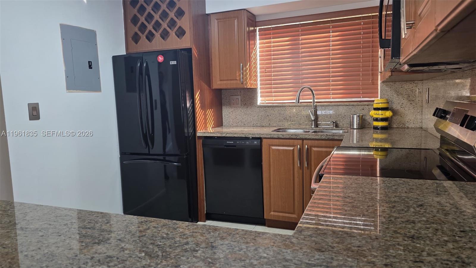 14905 Southwest 80th Street, Unit 217 Miami, FL 33193 - Photo 10 of 25 a kitchen with stainless steel appliances granite countertop a refrigerator a sink a stove and a refrigerator