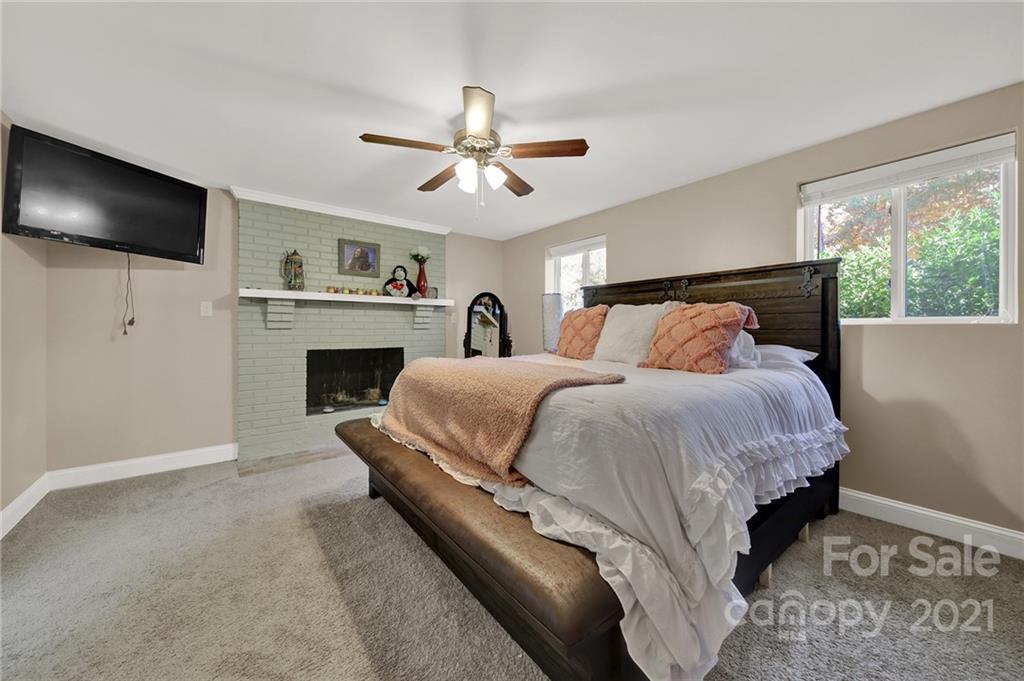 2430 Rice Planters Road Charlotte, NC 28273 - Photo 14 of 42 a spacious bedroom with a bed and a flat screen tv