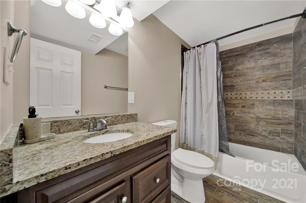 2430 Rice Planters Road Charlotte, NC 28273 - Photo 17 of 42 a bathroom with a granite countertop sink toilet and shower