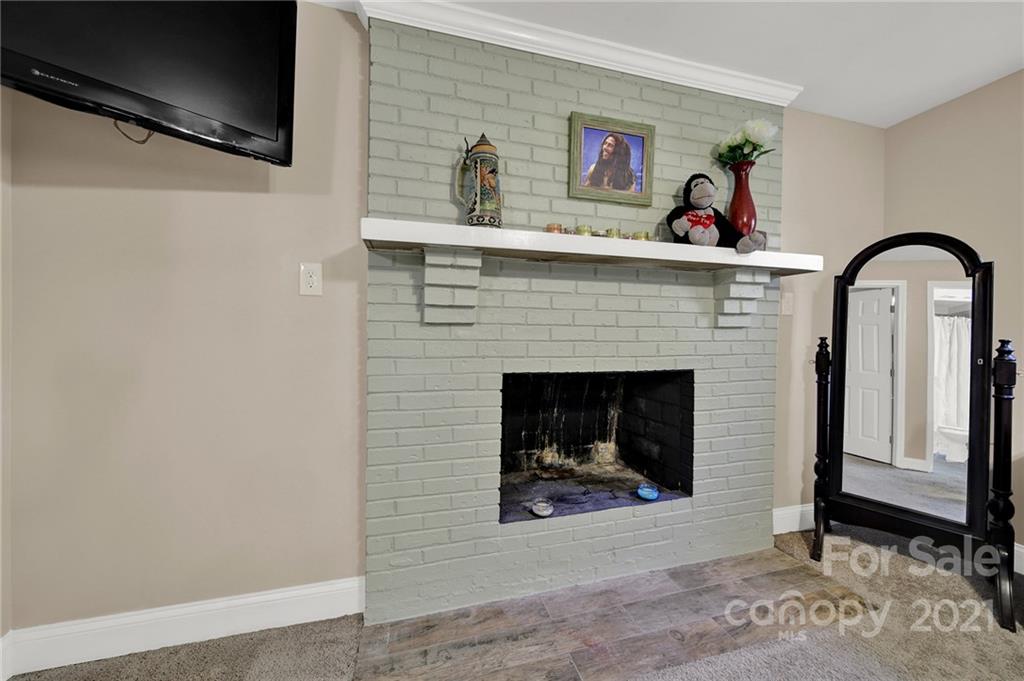 2430 Rice Planters Road Charlotte, NC 28273 - Photo 18 of 42 a living room with furniture and a fireplace