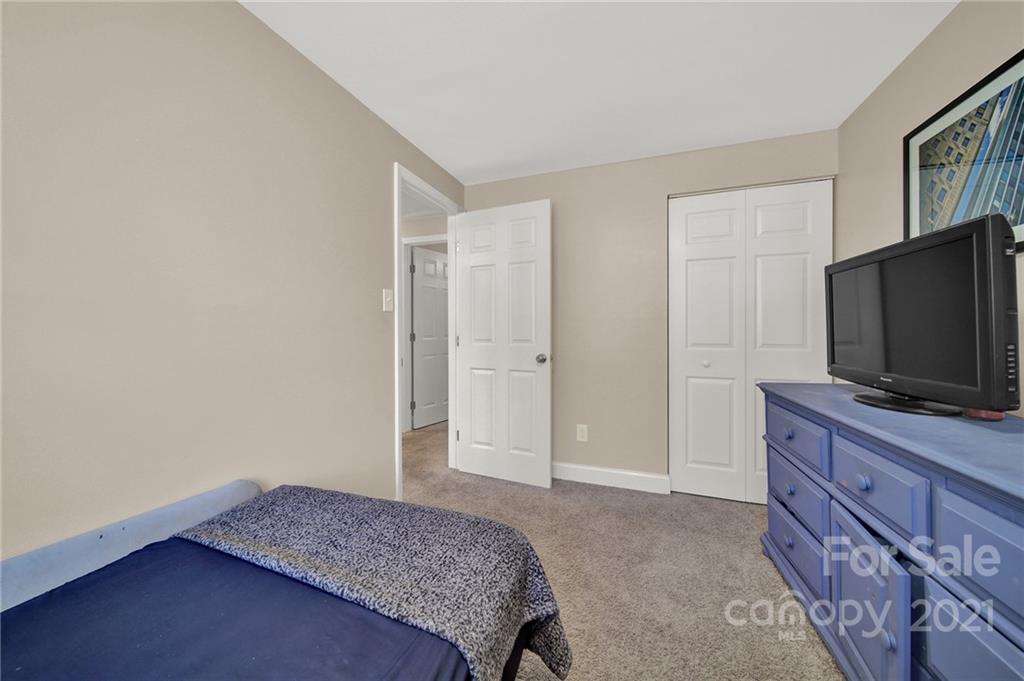 2430 Rice Planters Road Charlotte, NC 28273 - Photo 20 of 42 a bedroom with a bed and a flat screen tv