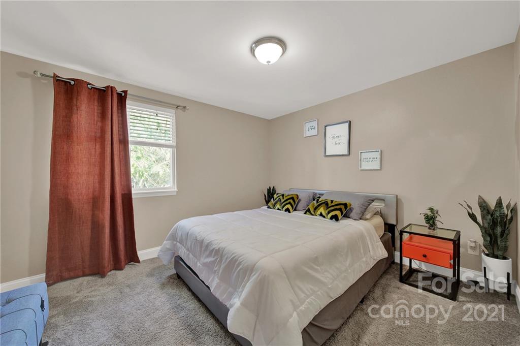 2430 Rice Planters Road Charlotte, NC 28273 - Photo 23 of 42 a bedroom with a bed and a table in it