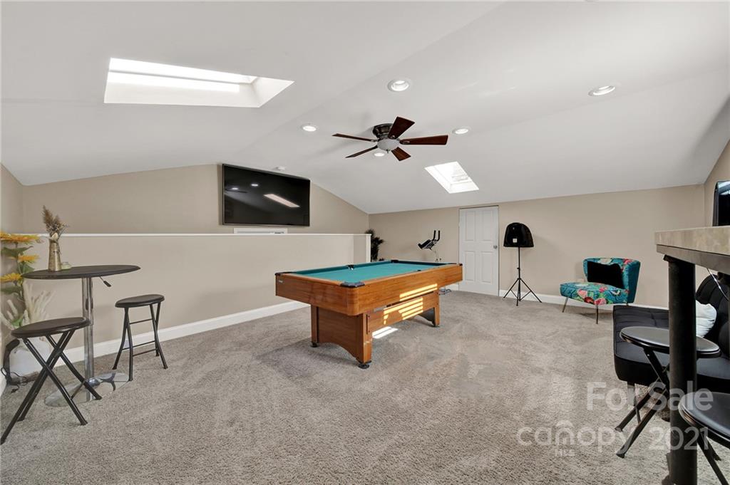 2430 Rice Planters Road Charlotte, NC 28273 - Photo 25 of 42 a living room with furniture and a flat screen tv