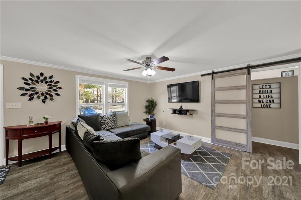 2430 Rice Planters Road Charlotte, NC 28273 - Photo 4 of 42 a living room with furniture and a flat screen tv