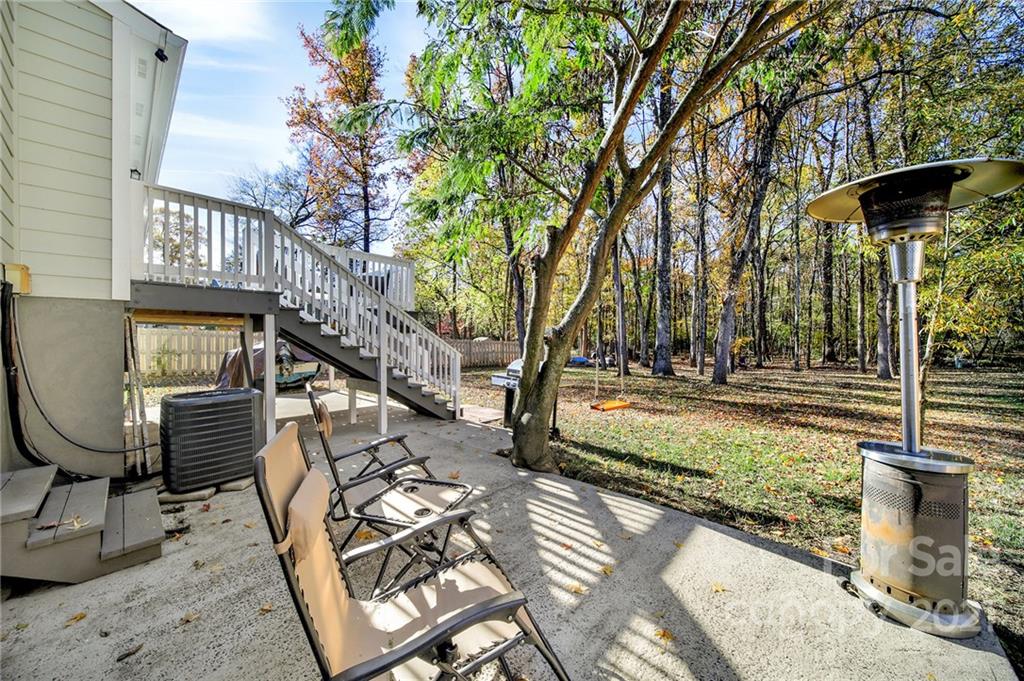 2430 Rice Planters Road Charlotte, NC 28273 - Photo 32 of 42 a view of a patio with table and chairs with wooden fence and plants