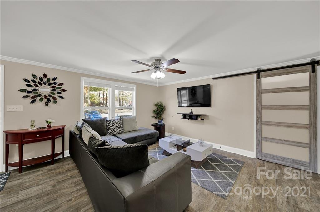 2430 Rice Planters Road Charlotte, NC 28273 - Photo 5 of 42 a living room with furniture and a flat screen tv