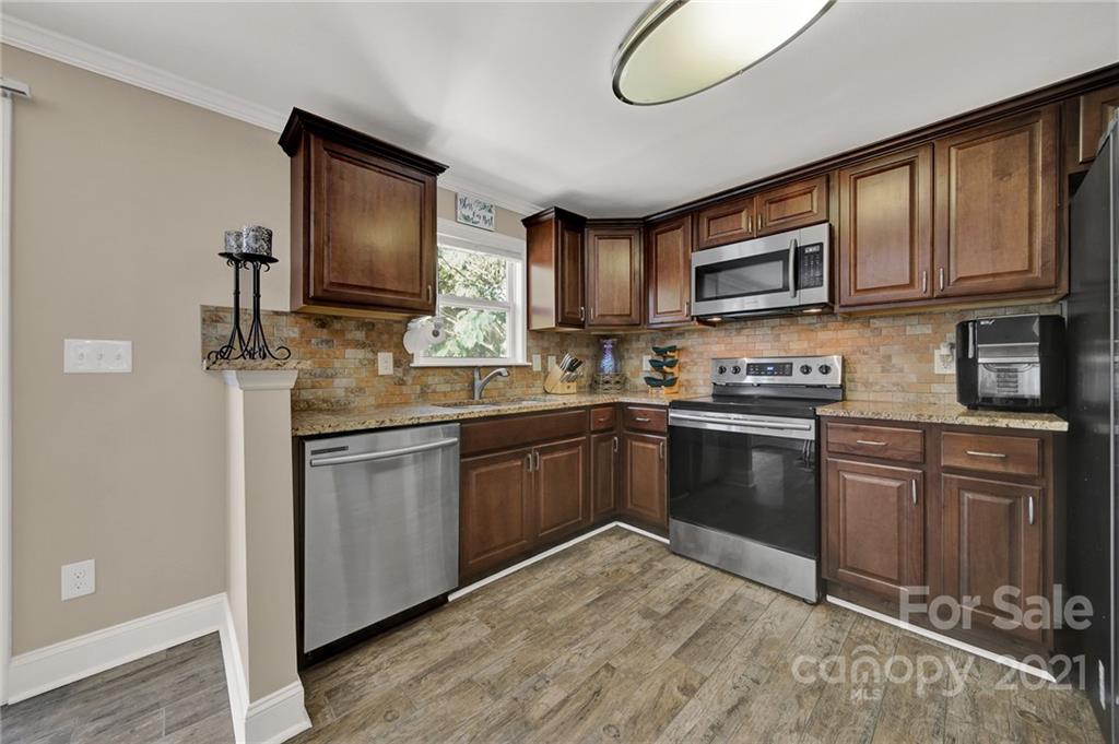 2430 Rice Planters Road Charlotte, NC 28273 - Photo 9 of 42 a kitchen with stainless steel appliances granite countertop a refrigerator stove top oven a sink and dishwasher