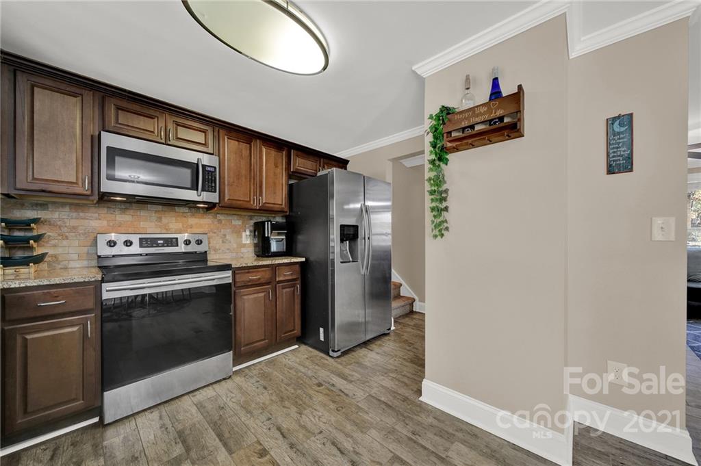 2430 Rice Planters Road Charlotte, NC 28273 - Photo 10 of 42 a kitchen with stainless steel appliances granite countertop a refrigerator microwave and sink